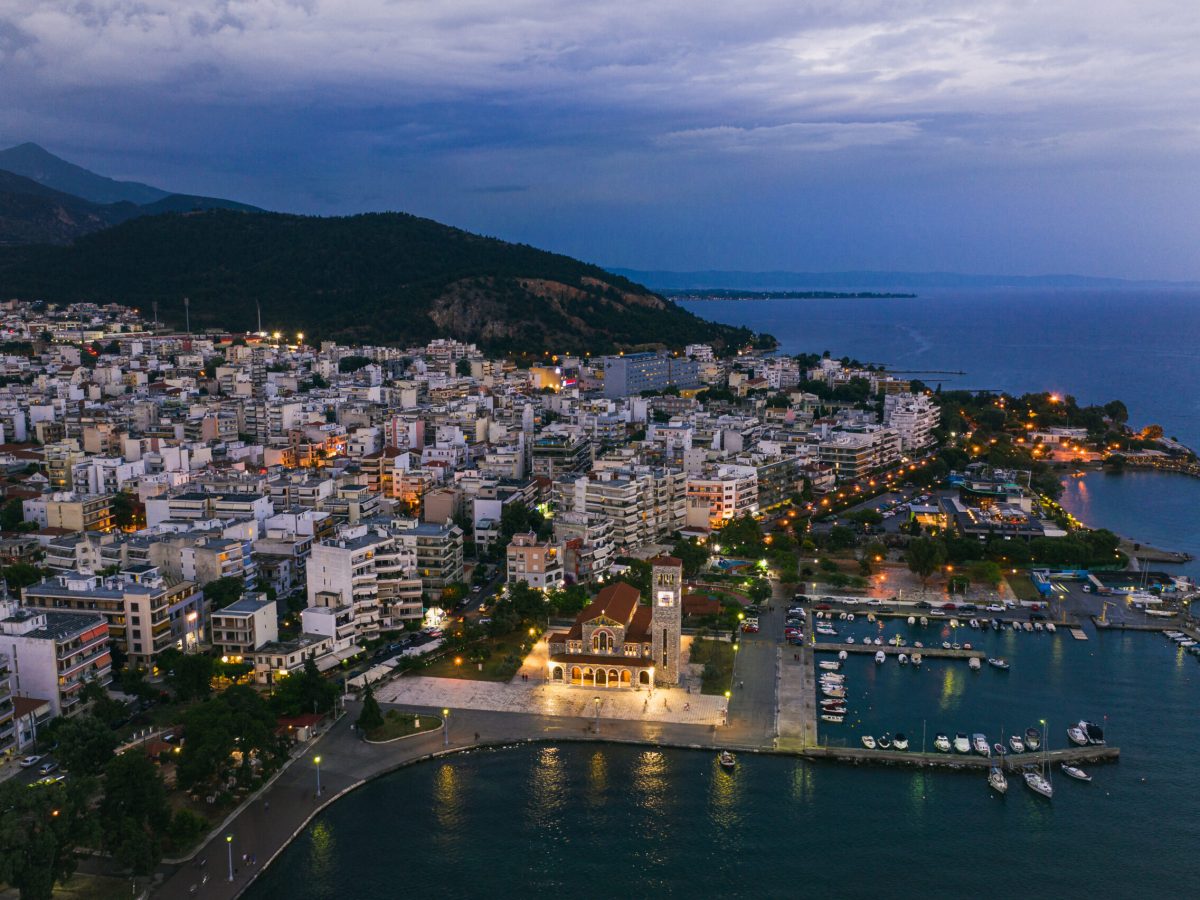 Private Transfer Between Volos And Meteora. Aerial panoramic view of Volos city at twilight Magnesia.
